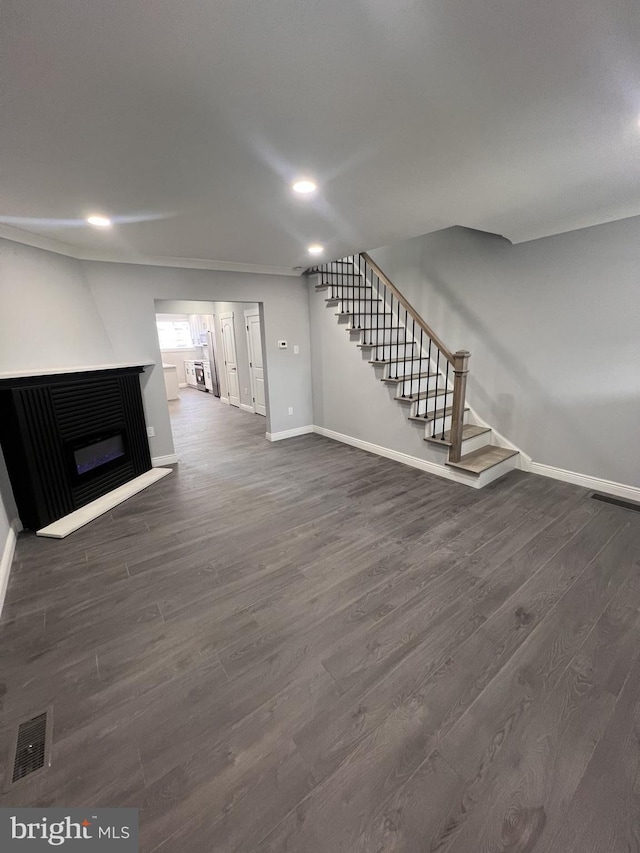 1712 W 65th Ave, Philadelphia, PA 19126 - unfurnished living room with stairway, baseboards, dark wood-style flooring, a glass covered fireplace, and recessed lighting