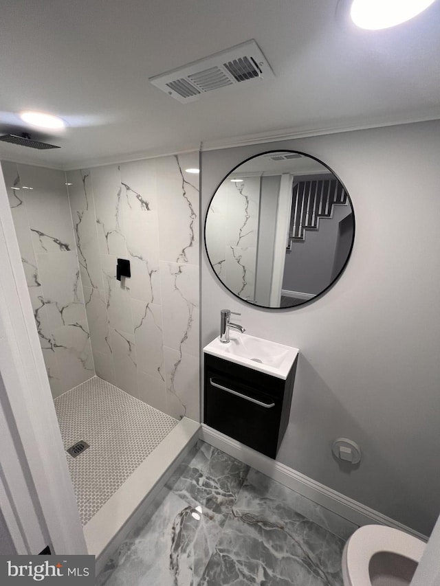 1712 W 65th Ave, Philadelphia, PA 19126 - bathroom featuring marble look tiles, a marble finish shower, vanity, toilet, and baseboards