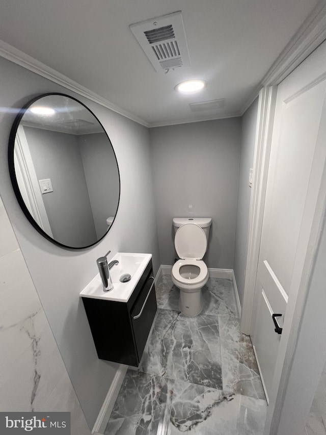 1712 W 65th Ave, Philadelphia, PA 19126 - half bath with marble look tile flooring, vanity, baseboards, toilet, and crown molding