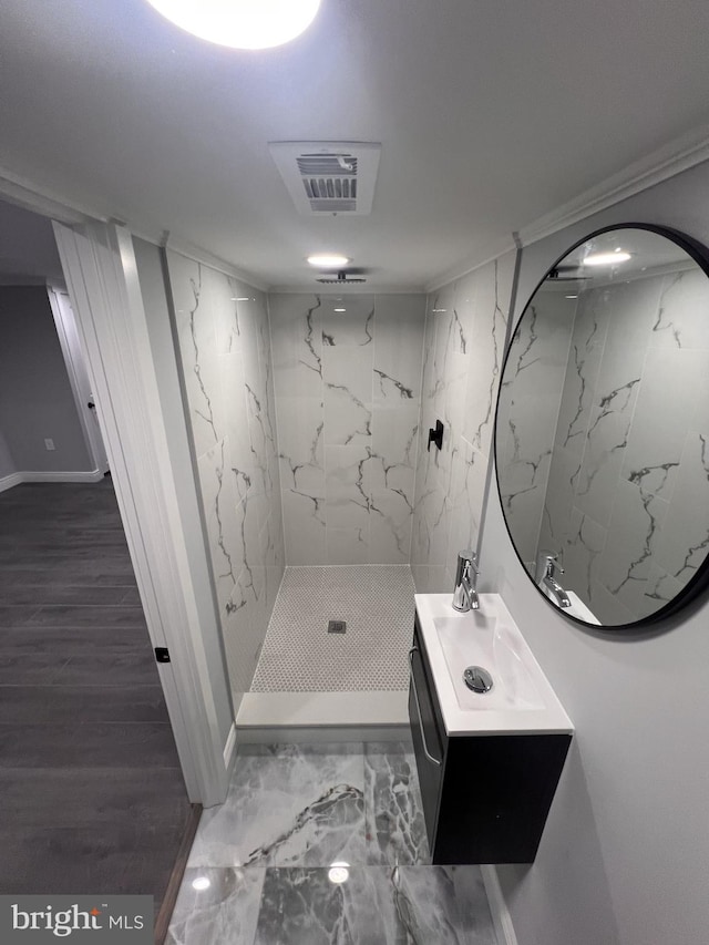 1712 W 65th Ave, Philadelphia, PA 19126 - bathroom with a marble finish shower, vanity, marble finish floors, and baseboards