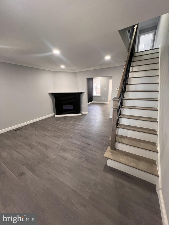 1712 W 65th Ave, Philadelphia, PA 19126 - unfurnished living room with baseboards, stairway, dark wood-style floors, recessed lighting, and a fireplace