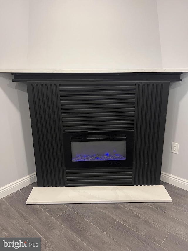 1712 W 65th Ave, Philadelphia, PA 19126 - detailed view of a glass covered fireplace, baseboards, and wood finished floors