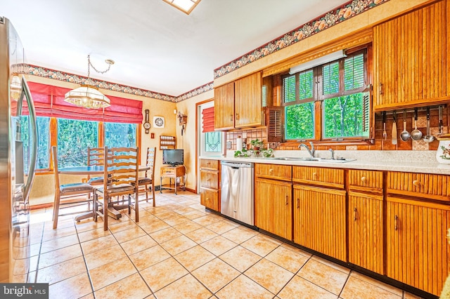 437 S 8th S, Galloway, NJ 08205 - kitchen with stainless steel appliances, light countertops, a sink, light tile patterned floors, and a chandelier