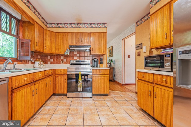 437 S 8th S, Galloway, NJ 08205 - kitchen with stainless steel appliances, under cabinet range hood, a sink, light countertops, and brown cabinetry