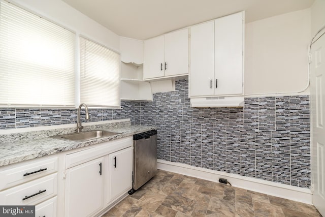 22 E 6th St, Pottstown, PA 19464 - kitchen with stainless steel dishwasher, a sink, white cabinetry, tasteful backsplash, and stone finish floors