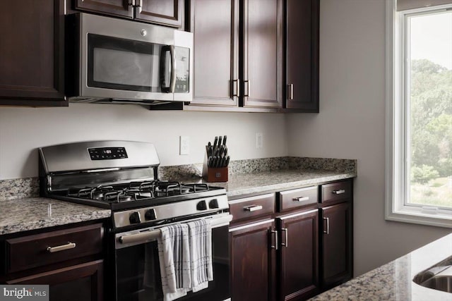1318 Ribbon Limestone Ter SE, Leesburg, VA 20175 - kitchen featuring stainless steel appliances, dark brown cabinets, and light stone countertops