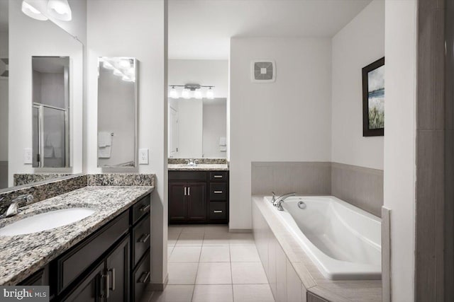 1318 Ribbon Limestone Ter SE, Leesburg, VA 20175 - bathroom with two vanities, tile patterned floors, a bath, and a stall shower