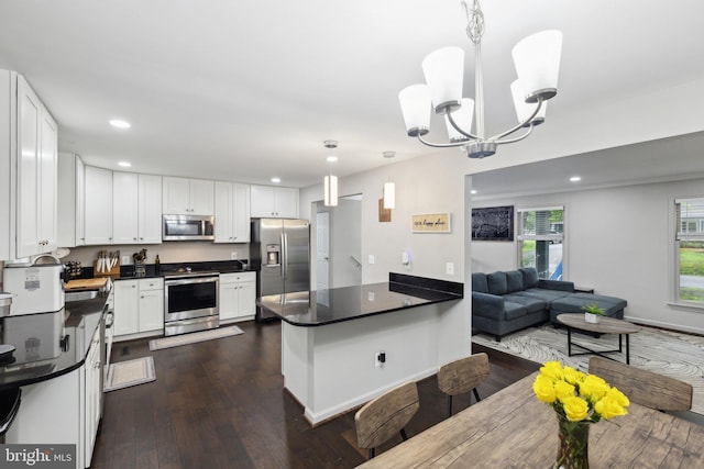 131 Oakwood Dr, Stafford, VA 22554 - kitchen featuring stainless steel appliances, dark countertops, a chandelier, a peninsula, and recessed lighting
