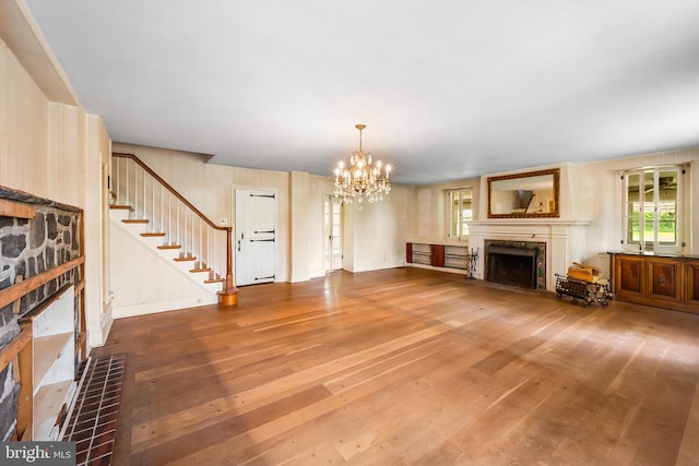 3577 Olde Bedminster Rd, Ottsville, PA 18942 - unfurnished living room with a fireplace, hardwood / wood-style floors, a chandelier, and plenty of natural light