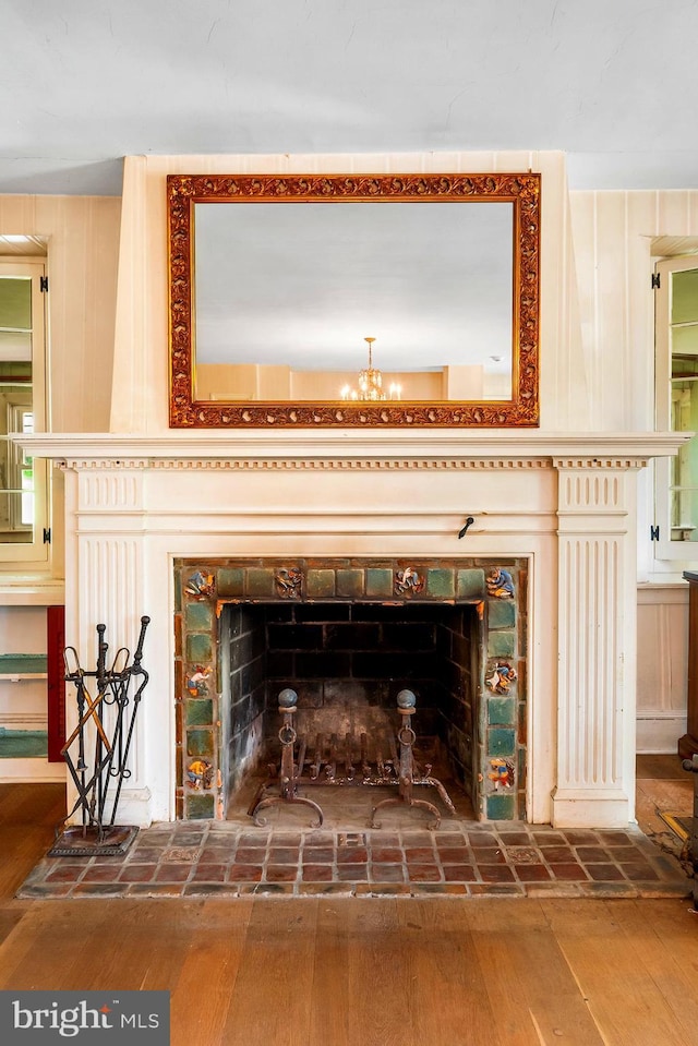 3577 Olde Bedminster Rd, Ottsville, PA 18942 - detailed view of a fireplace with raised hearth, wood finished floors, and a chandelier