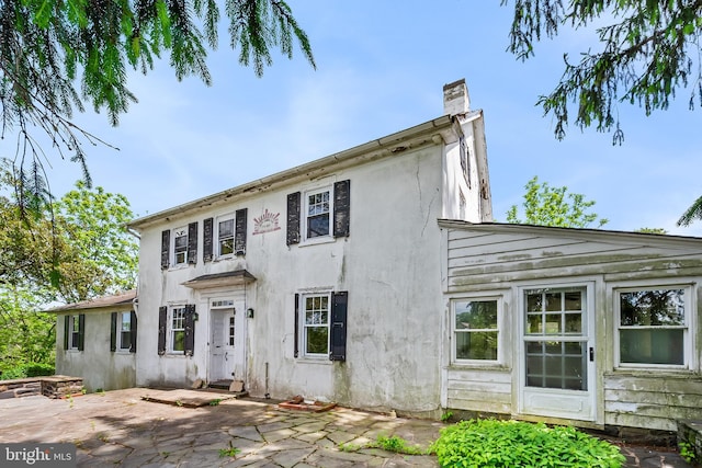 3577 Olde Bedminster Rd, Ottsville, PA 18942 - view of front of house with a chimney, a patio, and stucco siding