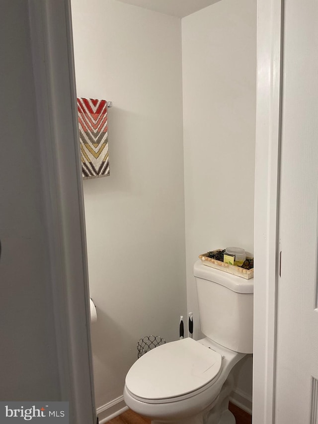 bathroom with toilet and baseboards