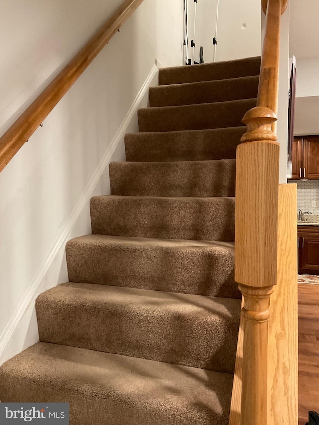 stairway featuring wood finished floors