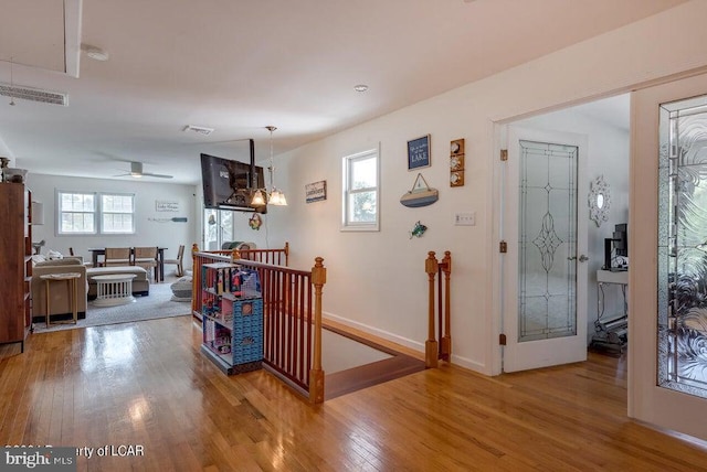 279 Apache Dr, Shickshinny, PA 18655 - hallway with an upstairs landing, wood finished floors, baseboards, and attic access