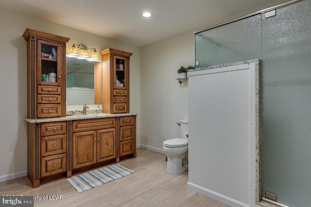 279 Apache Dr, Shickshinny, PA 18655 - full bathroom with wood finished floors, toilet, vanity, baseboards, and recessed lighting