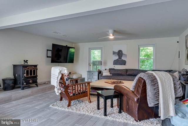 279 Apache Dr, Shickshinny, PA 18655 - living room with a wood stove, plenty of natural light, wood tiled floors, and ceiling fan