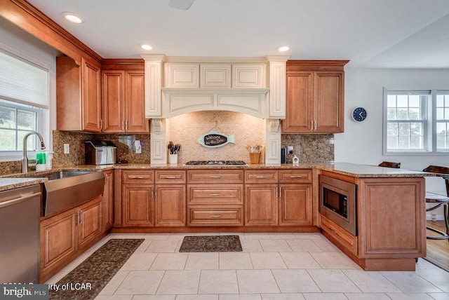 279 Apache Dr, Shickshinny, PA 18655 - kitchen featuring stainless steel appliances, a sink, light stone counters, brown cabinets, and recessed lighting