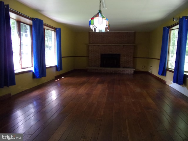 142 Fawn Rd, Reedsville, PA 17084 - unfurnished living room featuring hardwood / wood-style flooring and a brick fireplace