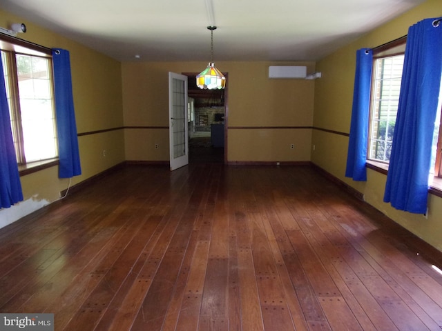 142 Fawn Rd, Reedsville, PA 17084 - empty room with dark wood-type flooring, a wall mounted air conditioner, and baseboards