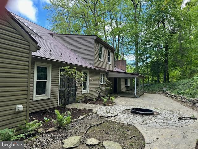 142 Fawn Rd, Reedsville, PA 17084 - back of property featuring a patio, metal roof, and a fire pit
