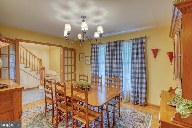 7857 Holly Branch Dr, Laurel, DE 19956 - dining space with stairs, a chandelier, and light wood finished floors