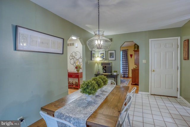 7857 Holly Branch Dr, Laurel, DE 19956 - dining room featuring arched walkways, a chandelier, and baseboards