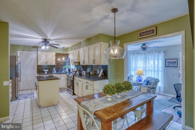 7857 Holly Branch Dr, Laurel, DE 19956 - kitchen with a ceiling fan, appliances with stainless steel finishes, dark countertops, a kitchen island, and a sink