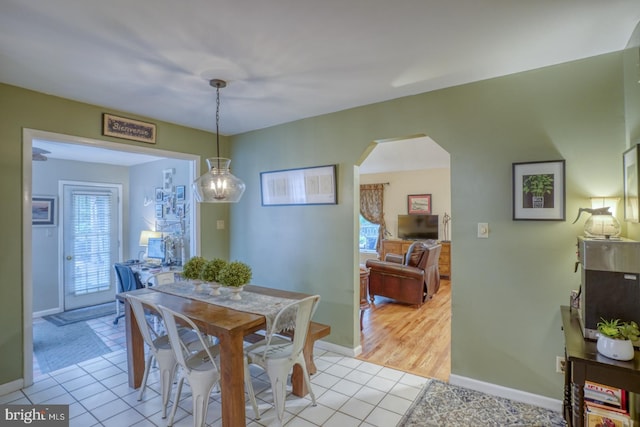 7857 Holly Branch Dr, Laurel, DE 19956 - dining area featuring arched walkways, light tile patterned flooring, and baseboards