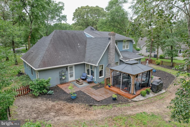 7857 Holly Branch Dr, Laurel, DE 19956 - rear view of property featuring a gazebo, a shingled roof, a deck, a chimney, and view of scattered trees