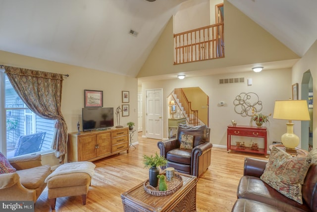 7857 Holly Branch Dr, Laurel, DE 19956 - living area with high vaulted ceiling, stairway, light wood-style flooring, and baseboards