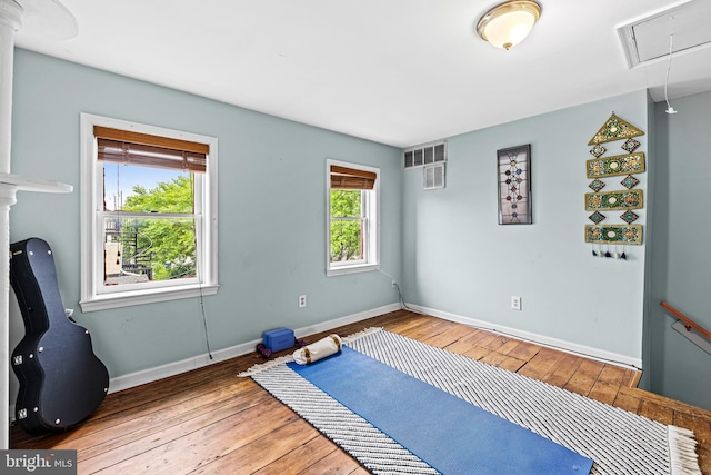 907 Mchenry St, Baltimore, MD 21223 - exercise room with hardwood / wood-style floors, attic access, and baseboards