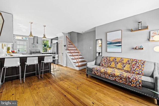 907 Mchenry St, Baltimore, MD 21223 - living area featuring light wood finished floors and stairs