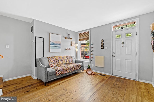 907 Mchenry St, Baltimore, MD 21223 - foyer with hardwood / wood-style flooring, baseboards, and heating unit