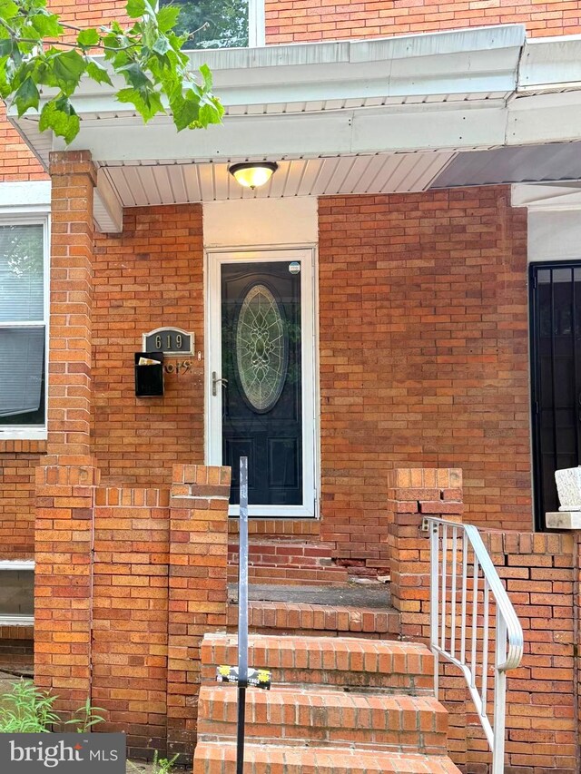 619 N Clinton St N, Baltimore, MD 21205 - doorway to property featuring brick siding