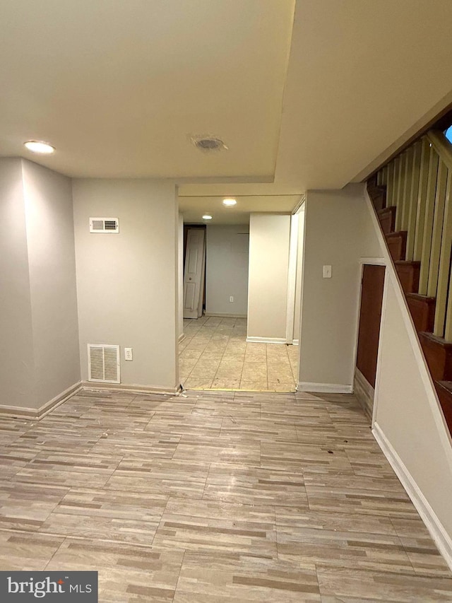 619 N Clinton St N, Baltimore, MD 21205 - finished below grade area with stairway, recessed lighting, and light wood-style flooring