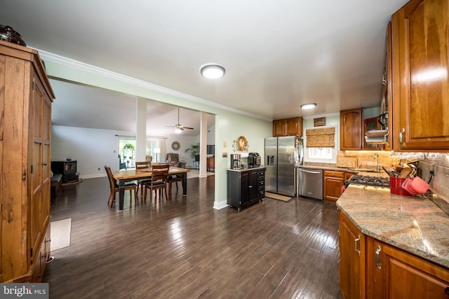 419 Breslin Rd, Joppa, MD 21085 - kitchen featuring appliances with stainless steel finishes, brown cabinets, ornamental molding, ceiling fan, and light stone counters