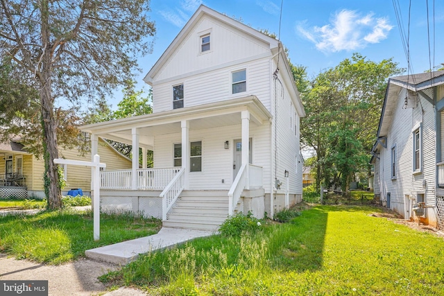 4016 35th St, Mount Rainier, MD 20712 - view of front of property with a porch, a front lawn, and board and batten siding