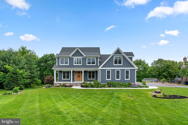 13492 Allnutt Ln, Highland, MD 20777 - colonial inspired home with board and batten siding, a front lawn, and a porch