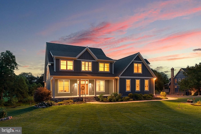 13492 Allnutt Ln, Highland, MD 20777 - view of front facade featuring covered porch, board and batten siding, and a front lawn