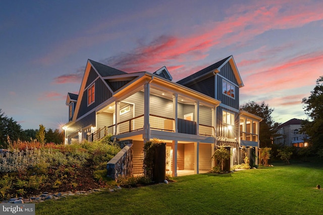 13492 Allnutt Ln, Highland, MD 20777 - back of property at dusk featuring board and batten siding, a lawn, and a balcony
