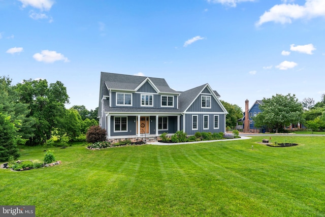 13492 Allnutt Ln, Highland, MD 20777 - view of front of home with a porch, board and batten siding, and a front lawn