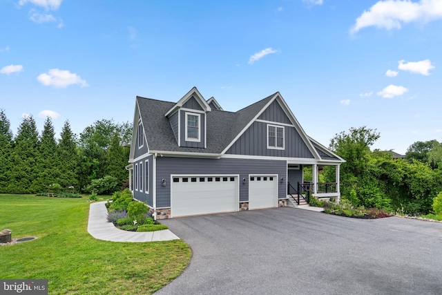 13492 Allnutt Ln, Highland, MD 20777 - view of front of home with a garage, board and batten siding, a front lawn, asphalt driveway, and a porch