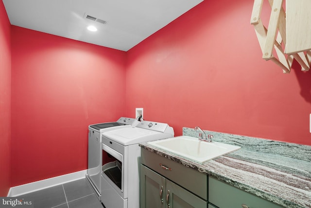 13492 Allnutt Ln, Highland, MD 20777 - washroom featuring washing machine and clothes dryer, tile patterned floors, baseboards, and cabinet space