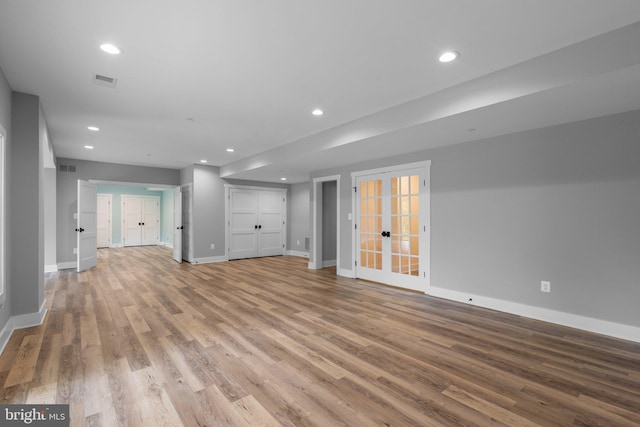 13492 Allnutt Ln, Highland, MD 20777 - unfurnished living room with baseboards, wood finished floors, recessed lighting, and french doors