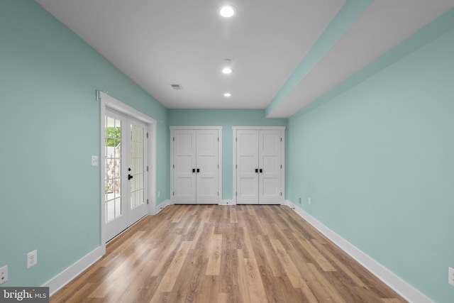 13492 Allnutt Ln, Highland, MD 20777 - unfurnished bedroom with multiple closets, baseboards, recessed lighting, and light wood-style flooring