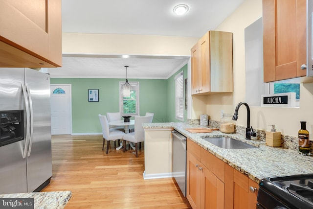 7906 Garland Ave, Takoma Park, MD 20912 - kitchen featuring stainless steel appliances, a sink, light wood finished floors, baseboards, and light stone counters