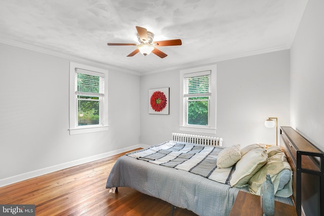 7906 Garland Ave, Takoma Park, MD 20912 - bedroom featuring radiator, multiple windows, wood finished floors, baseboards, and crown molding