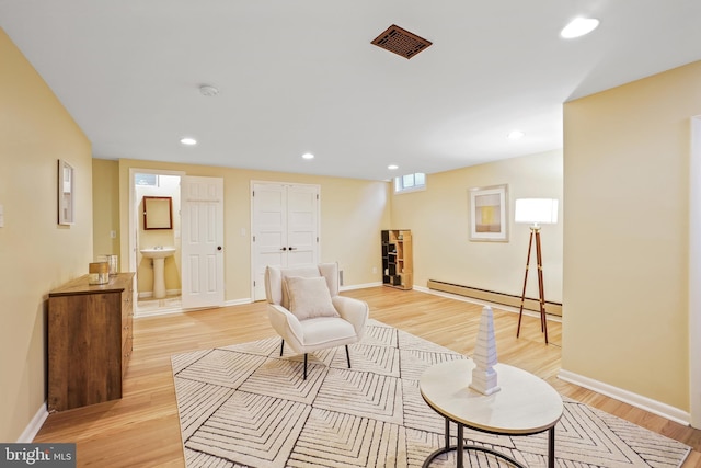7906 Garland Ave, Takoma Park, MD 20912 - sitting room featuring a baseboard heating unit, light wood-style floors, recessed lighting, and baseboards