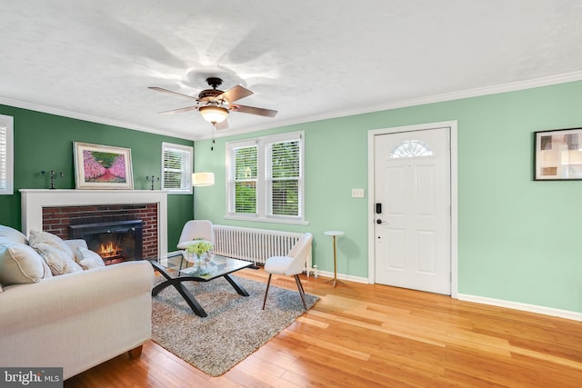 7906 Garland Ave, Takoma Park, MD 20912 - living area with a brick fireplace, baseboards, hardwood / wood-style flooring, ornamental molding, and radiator