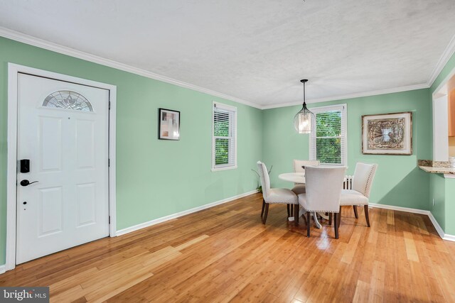 7906 Garland Ave, Takoma Park, MD 20912 - dining room featuring baseboards, light wood-style flooring, and crown molding
